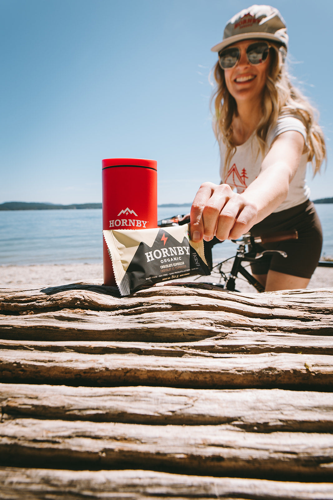 Woman grabbing hornby bar on the beach with bike