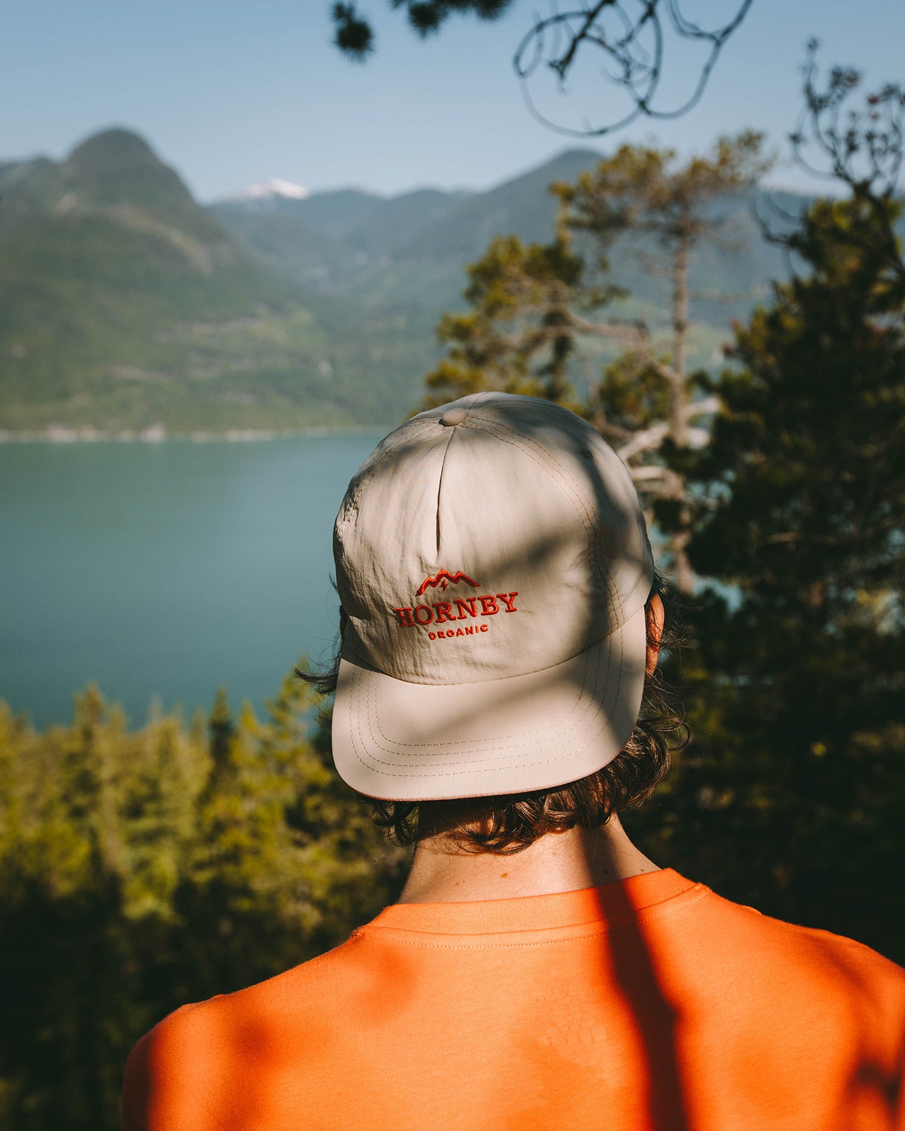 man in forest wearing backwards hornby organic hat 