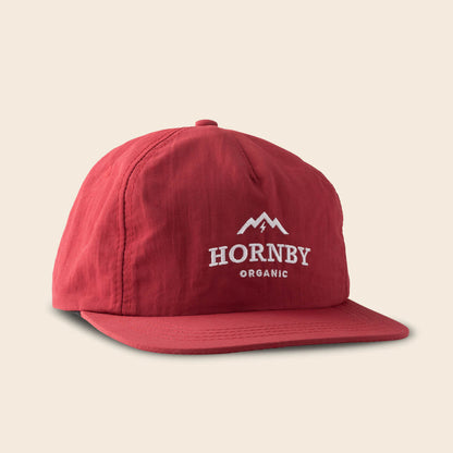 Red cap with 'Hornby Organic' logo on a beige background